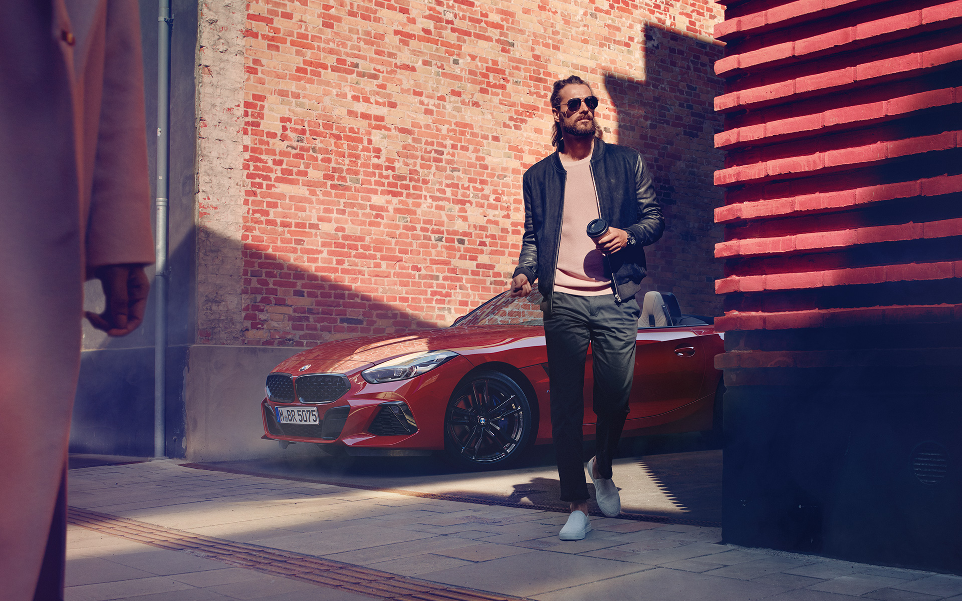 Man in a side street in front of BMW Z4 Roadster (G29)